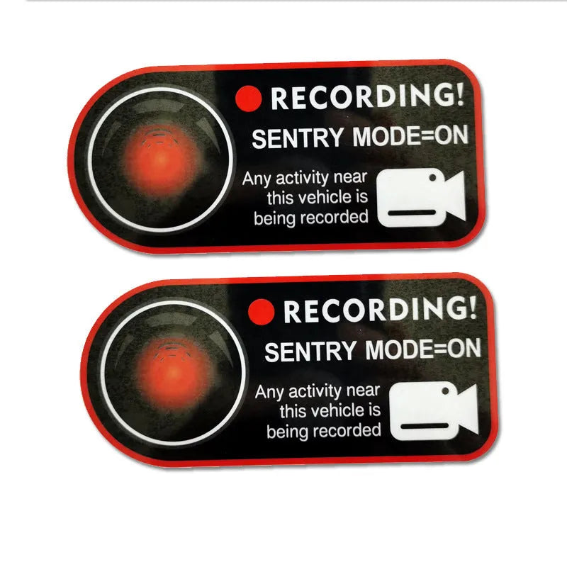 Pair of rectangular 11x5cm Tesla Sentry Mode warning stickers with English text on clear electrostatic backing.