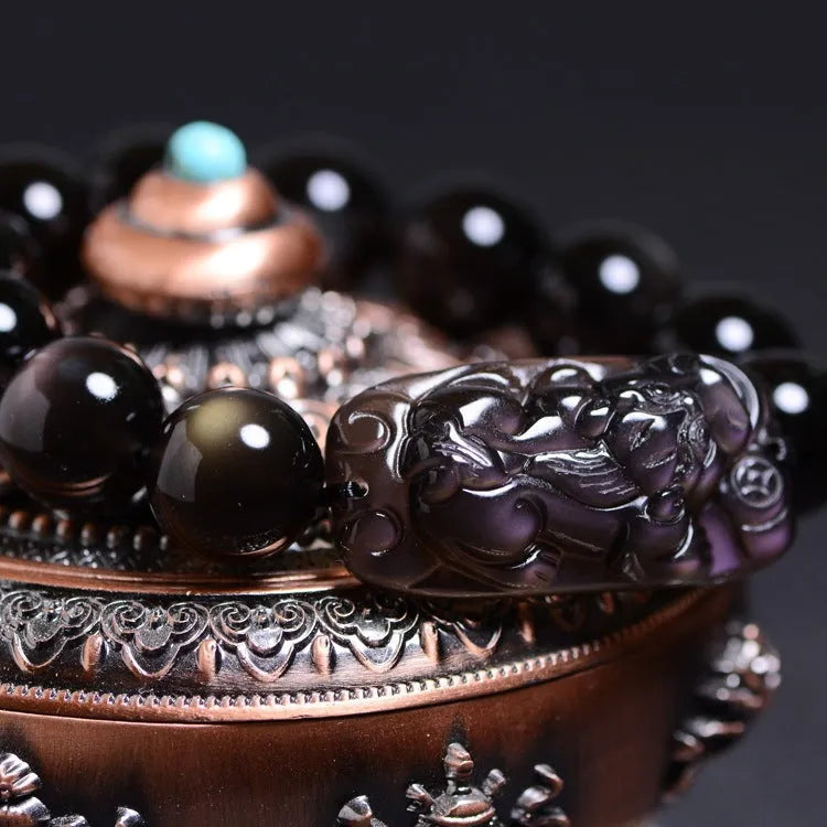 Natural crystal Pi Xiu bracelet with geometric beads on a wrist, showing ice stone colour.