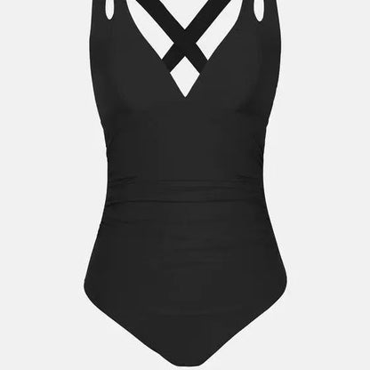 One-piece swimsuit with triangle bikini top and cross shoulder straps in solid colour