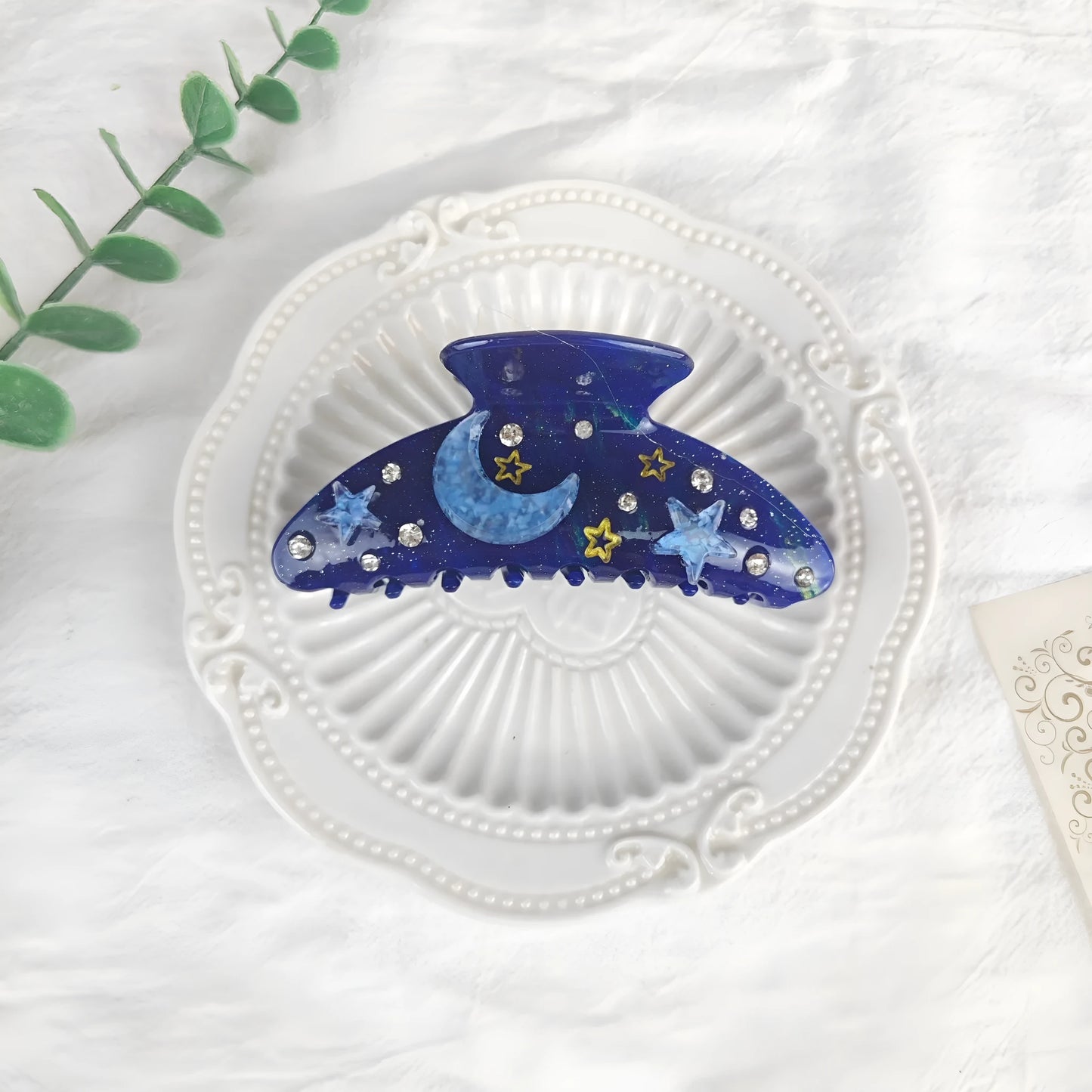 Oversized star barrettes in starry sky colours showing minimalist design and irregular elements