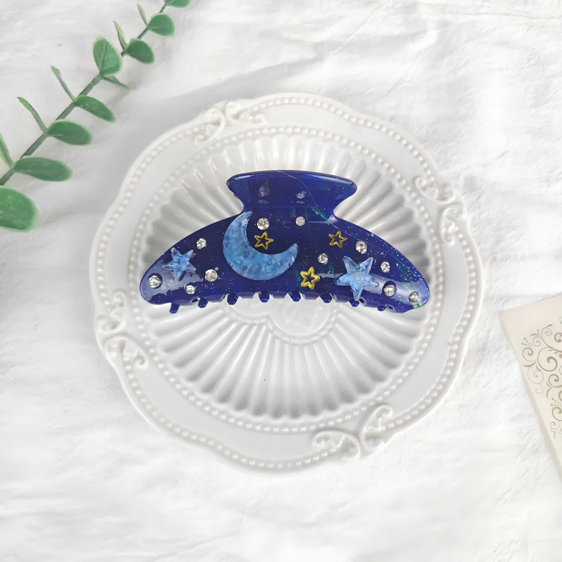 Oversized star barrettes in starry sky colours showing minimalist design and irregular elements