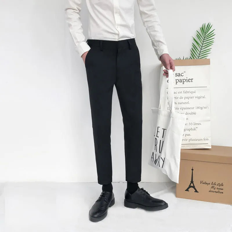 Man wearing black slim straight-leg loose fit cotton trousers with a drawstring waist
