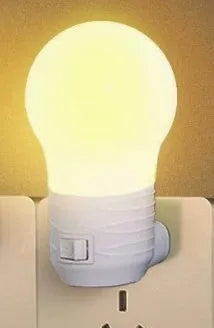 Plug-in bedside baby night light in white, blue, or pink shell with round shape.