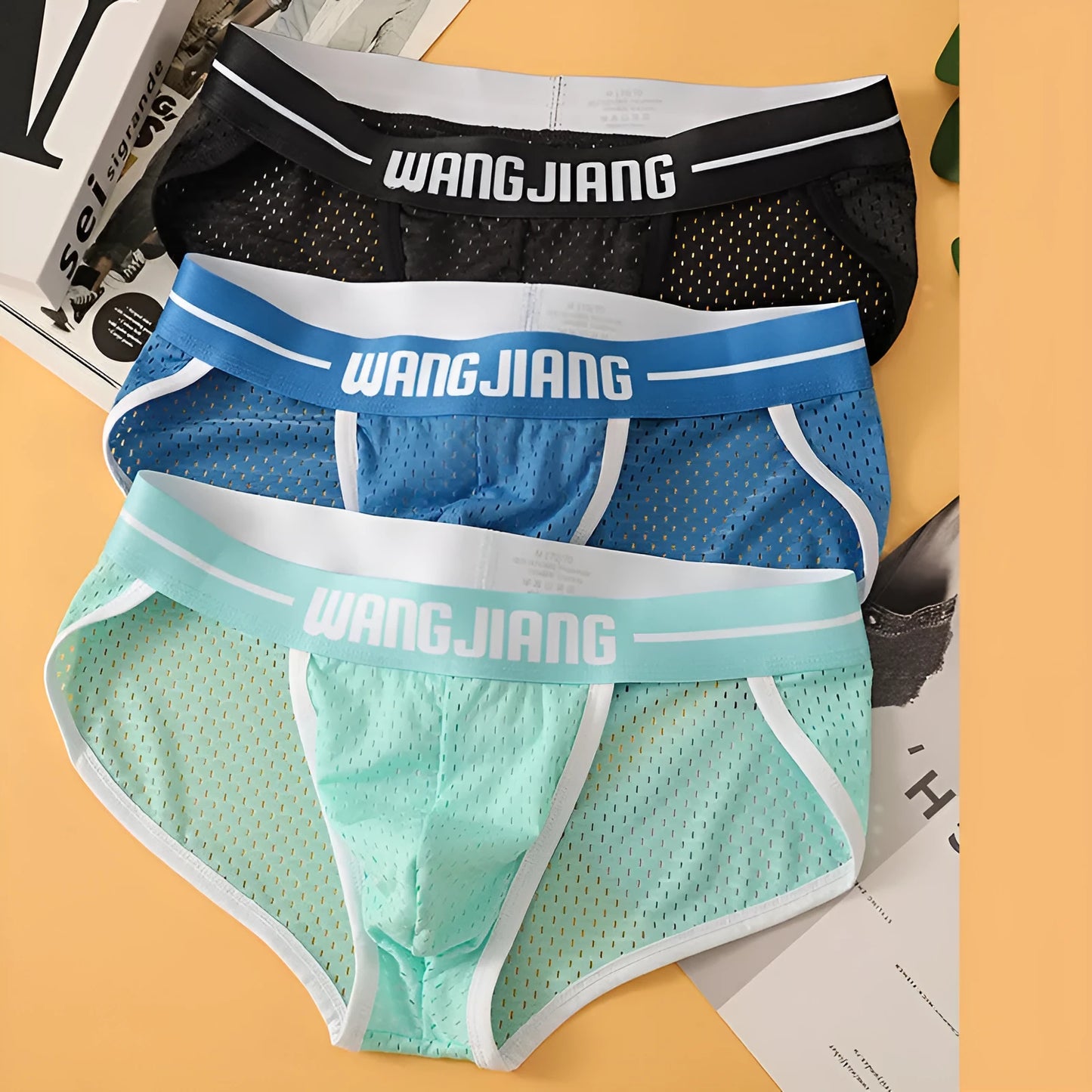 Men's solid colour Ice Silk triangle briefs on a white background, showing the mesh fabric texture.