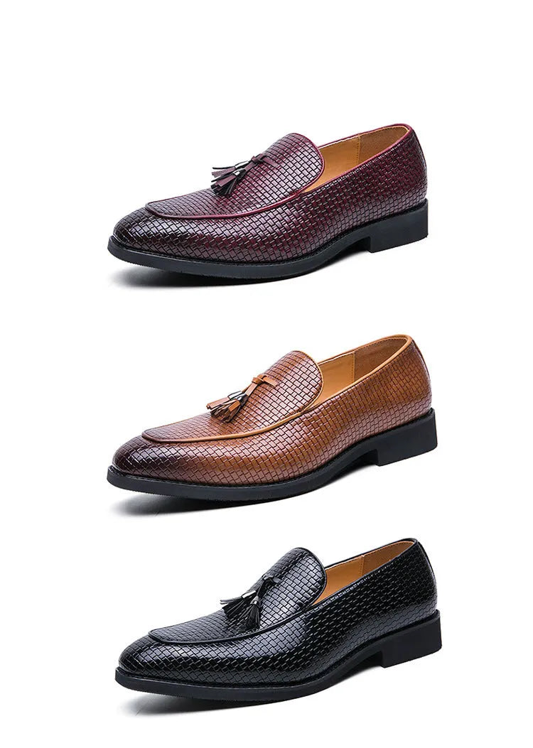Men's black pointed toe slip on shoes with a tassel detail on the upper.