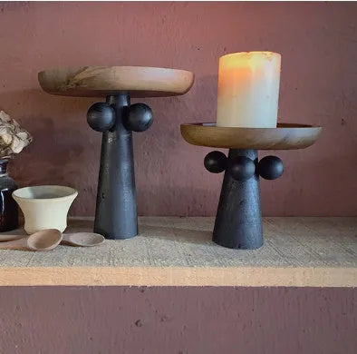 Round beech wood tray with high legs for candles and aromatherapy accessories on wooden table