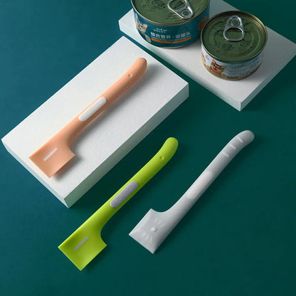 Green long-handle pet feeding spoon with right-angle head for scraping canned wet food.