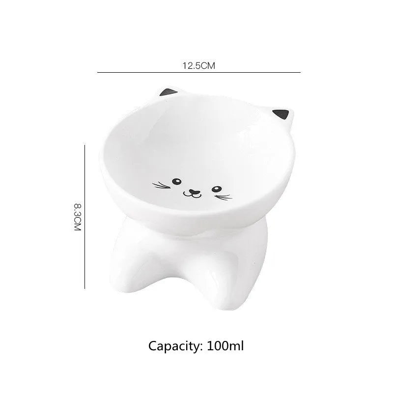 White ceramic pet food bowl with raised cat face design for cats and small dogs