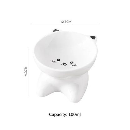 White ceramic pet food bowl with raised cat face design for cats and small dogs