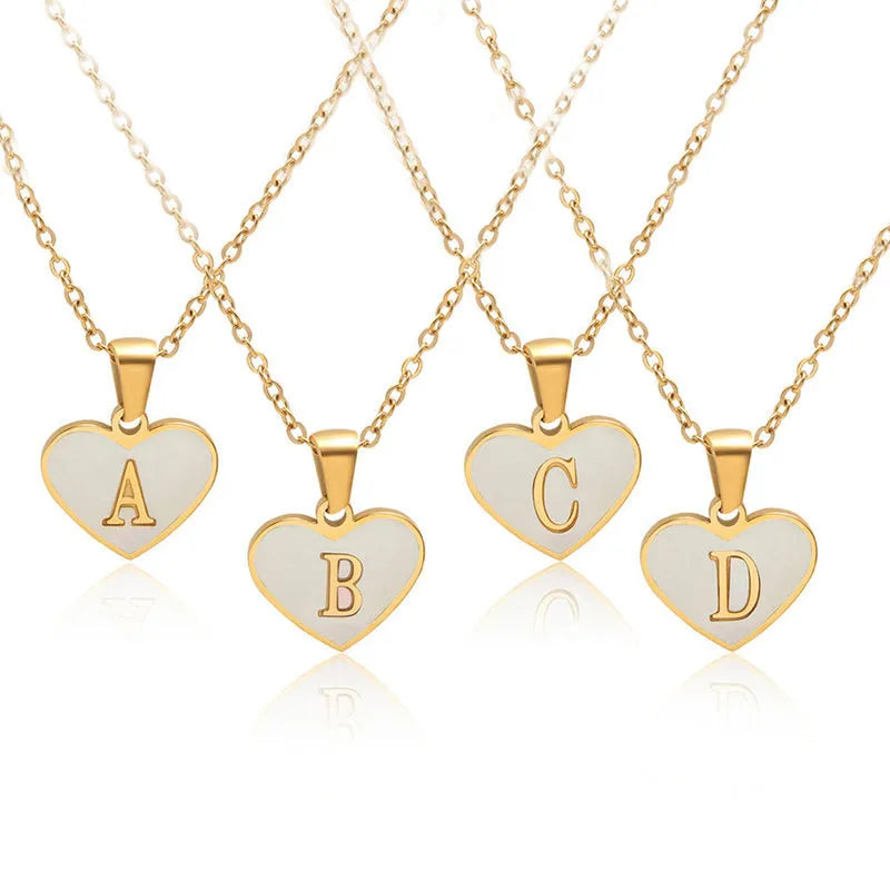 Gold-plated heart necklace with white shell pendant showing letter personalisation option