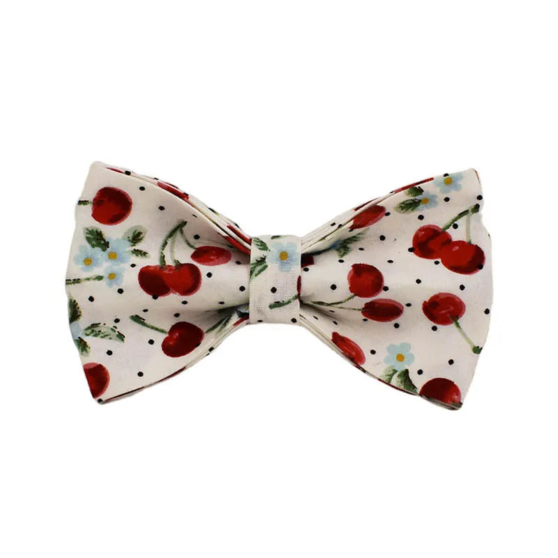 Red cherry printed dog collar with light gold buckle and matching leash, bow, vest and poop bag holder set