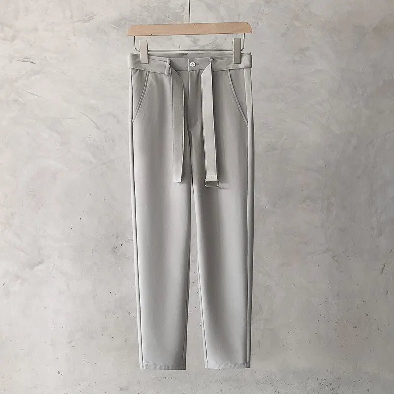 Boys slim straight wool trousers in tapered fit on hanger, showing straight leg opening.