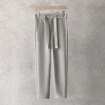 Boys slim straight wool trousers in tapered fit on hanger, showing straight leg opening.