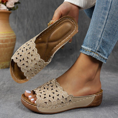 Women's wedge beach slippers with flower cutout design on PVC upper, shown in light brown colour.