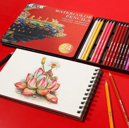 Metal tin box open to show 24 water-soluble coloured pencils with brush tips in assorted colours.