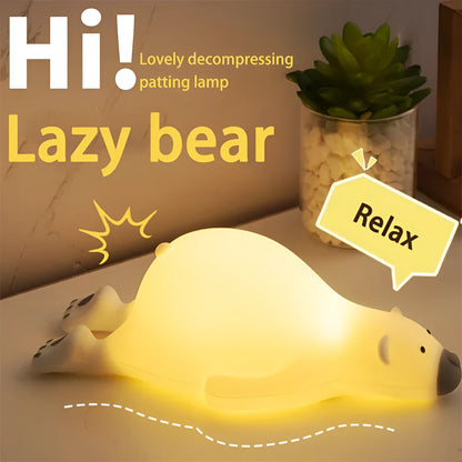 White bear-shaped silicone night light on a table with USB cable.