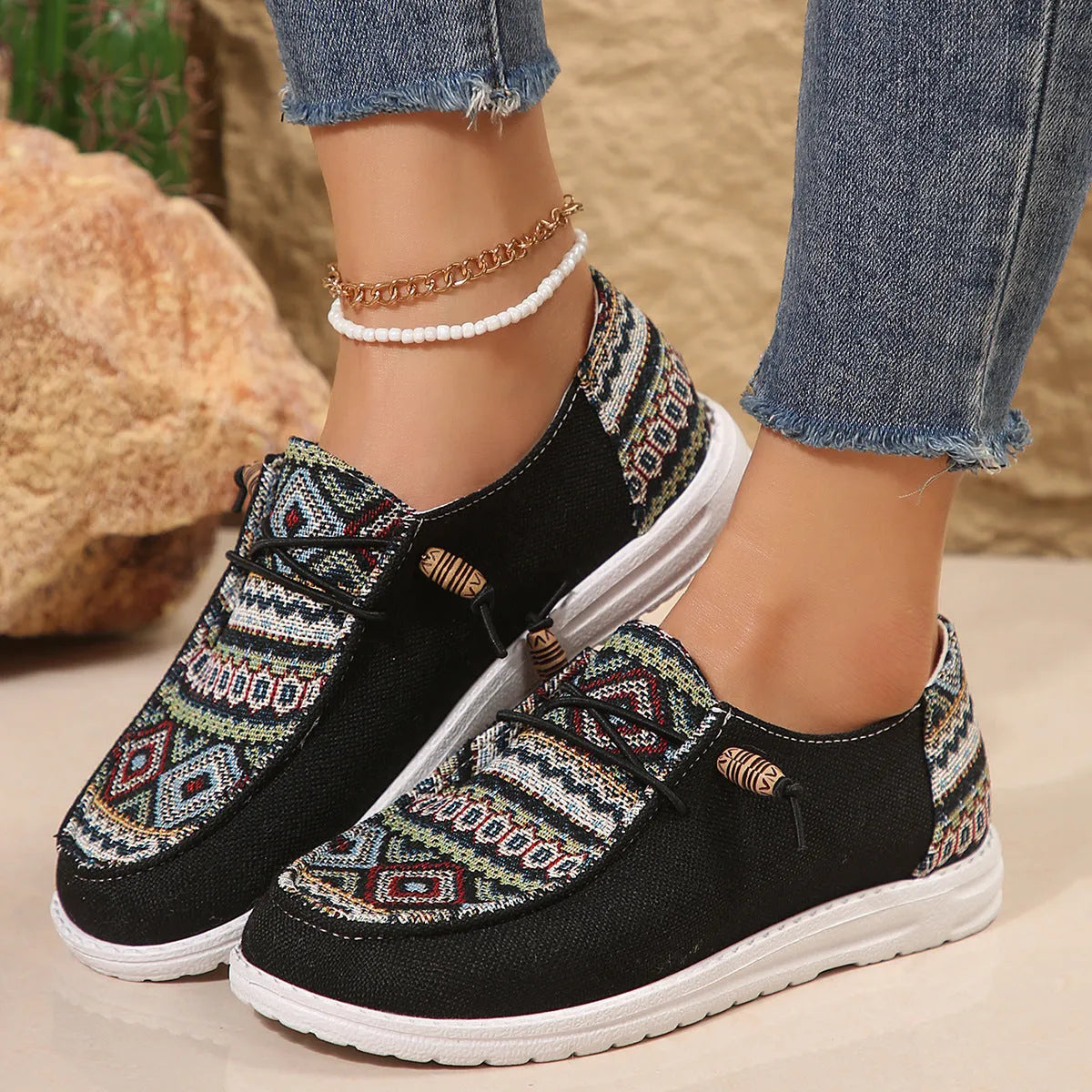 Women's black slip-on flat shoes with round toe and low-top design on a neutral background.