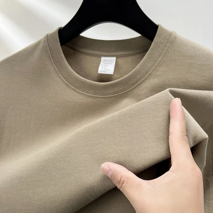 Men's thin cotton drop shoulder t-shirt on a hanger, shown in a light colour.