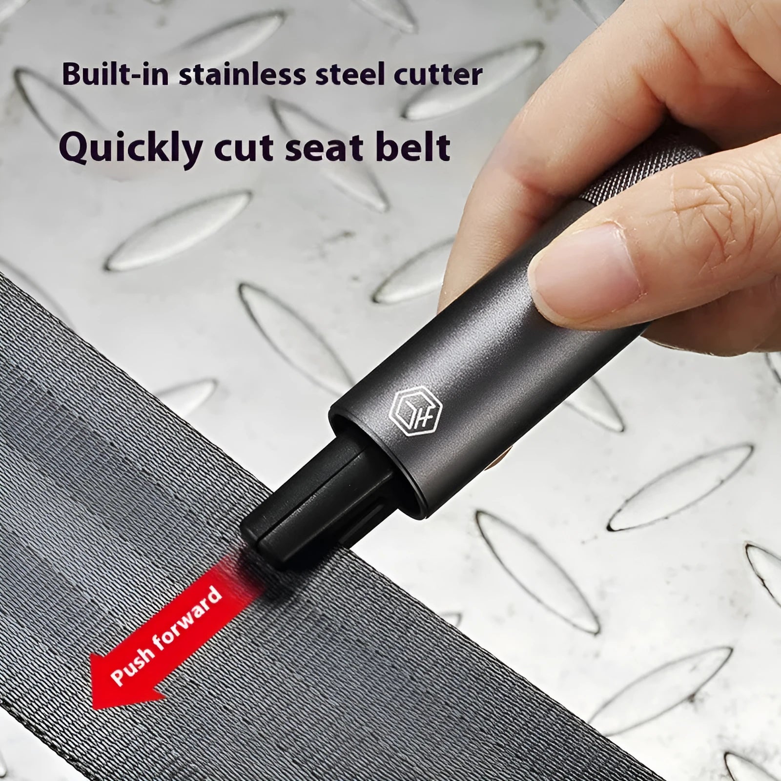 Gun grey aluminium car safety hammer with seatbelt cutter on a 3M rubber base next to a test glass.