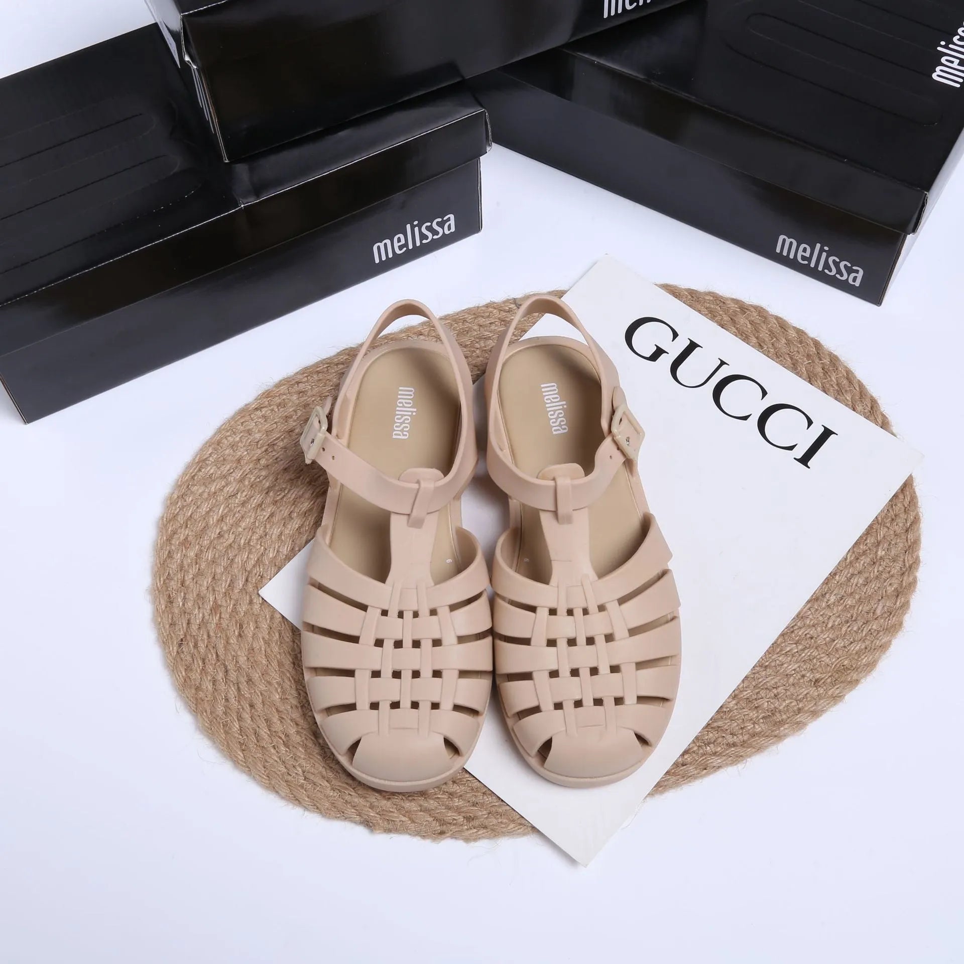 Matte black Roman sandals with vintage weave pattern, buckle fastening, and low-top PVC construction