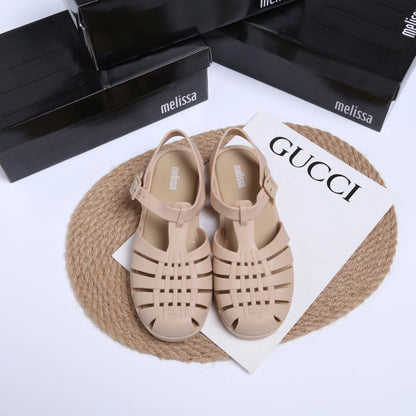 Matte black Roman sandals with vintage weave pattern, buckle fastening, and low-top PVC construction