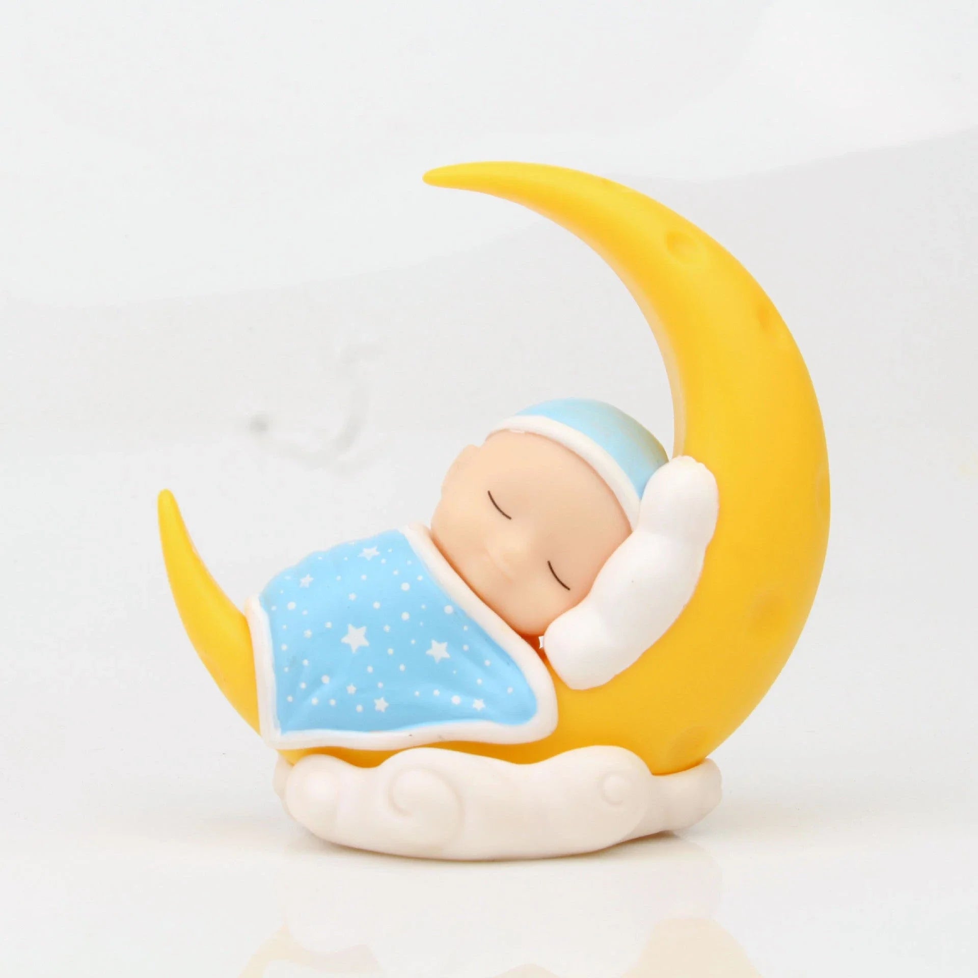 Adorable moon-themed cake decorations and party supplies for baby birthday celebrations