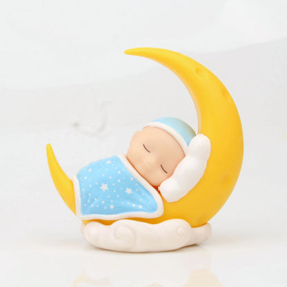 Adorable moon-themed cake decorations and party supplies for baby birthday celebrations