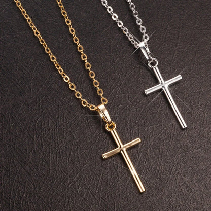 Elegant cross pendant necklace in gold and silver tones, a timeless British accessory