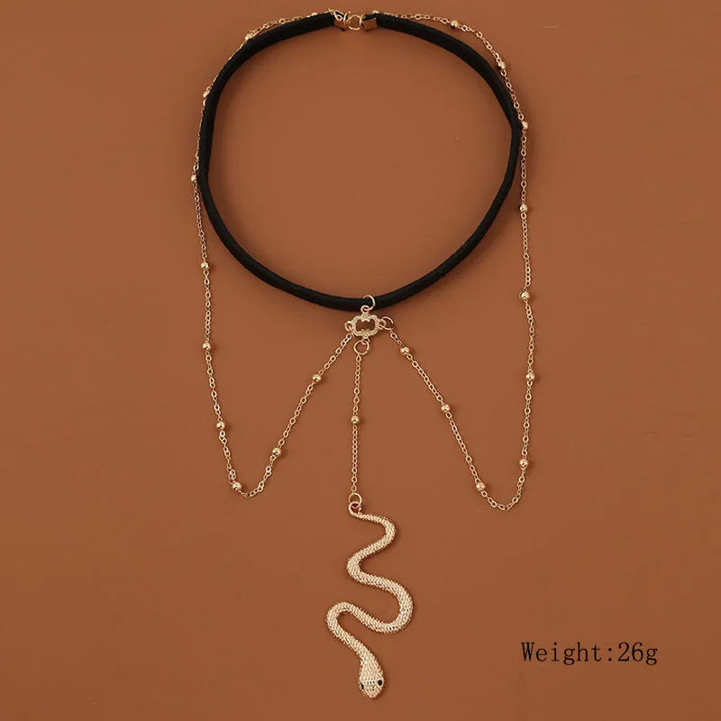 Gold colour alloy thigh chain with big snake pendant and beaded geometric leg chain design