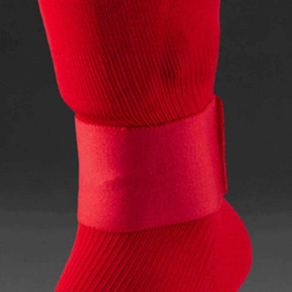 Rubber football shin guard retention tape belt shown in red, blue, black, and white colour options.