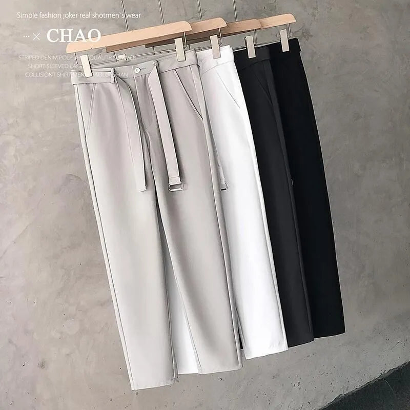 Boys slim straight wool trousers in tapered fit on hanger, showing straight leg opening.
