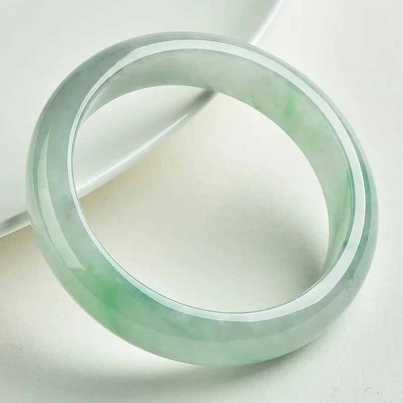 Light green jade stone bracelet showing natural mineral texture on wrist