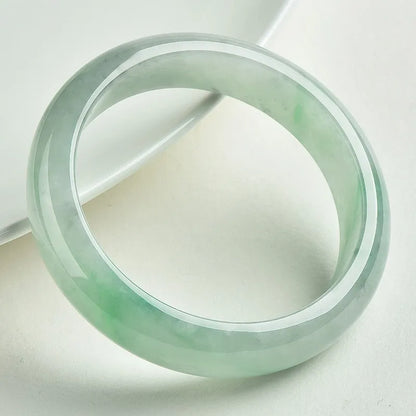 Light green jade stone bracelet showing natural mineral texture on wrist