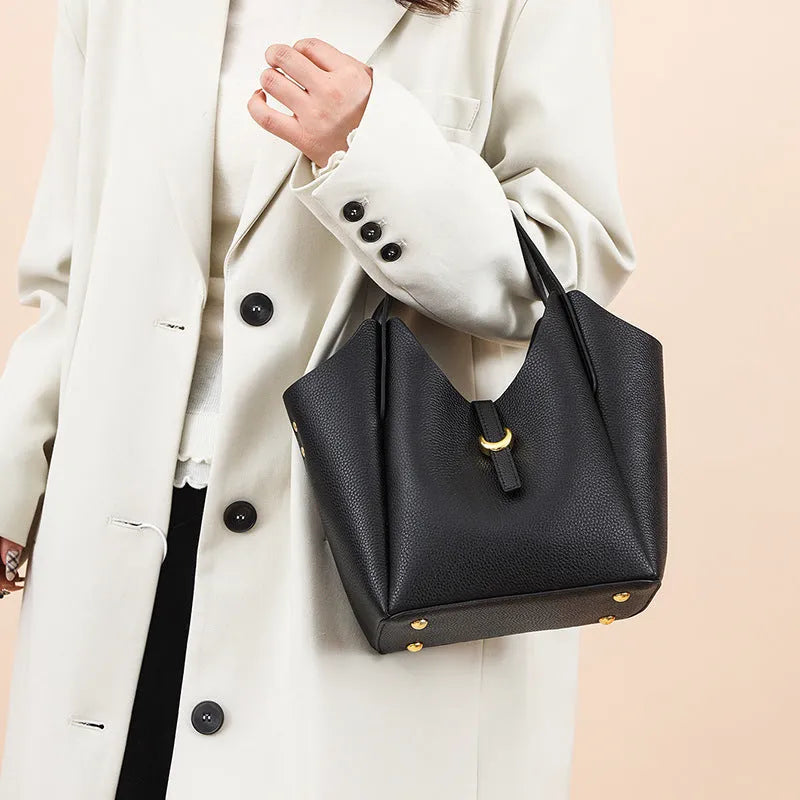Genuine cowhide leather women's bucket bag in retro style with contrast stitching.