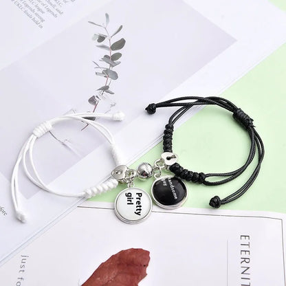 A pair of magnet couple bracelets with a suction clasp, showing various design options like clovers, crowns, and hearts.