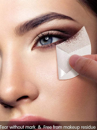 Half-moon shaped under-eye makeup shields on skin during eyeshadow application