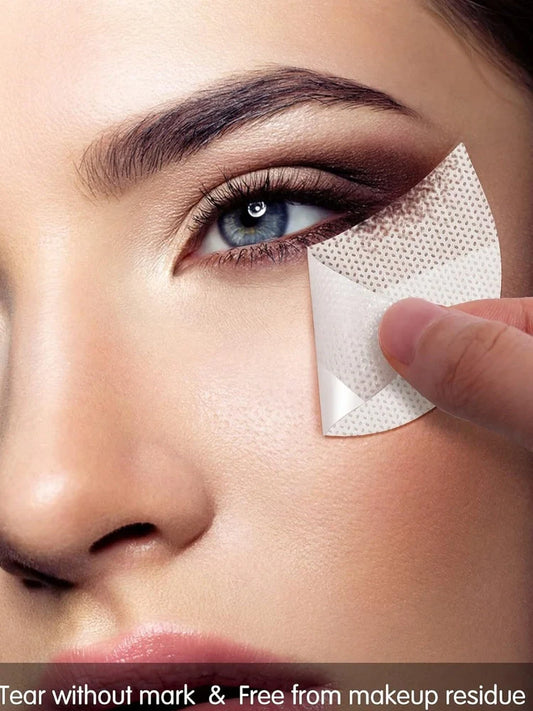 Half-moon shaped under-eye makeup shields on skin during eyeshadow application