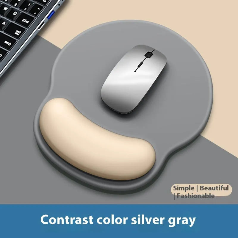 Silicone mouse mat with integrated wrist rest in a gradient blue black colour on a desk.