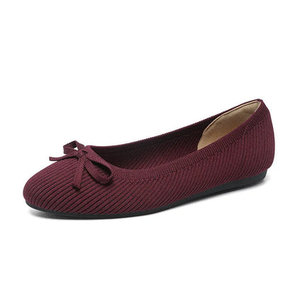 Women's round toe flat pumps with bow detail in butterfly colours showing fabric upper and shallow mouth opening