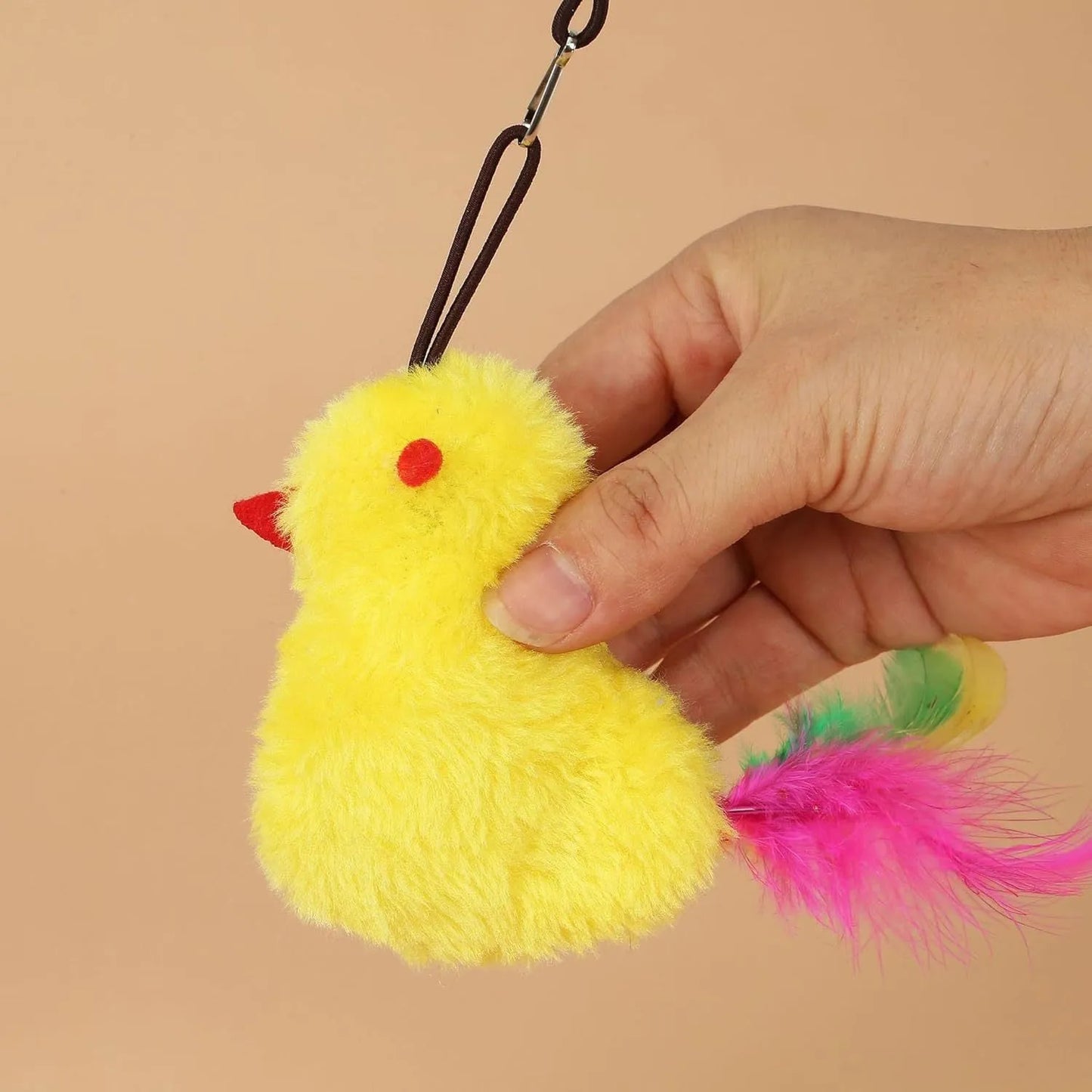 Interactive cat toy hanging from door frame with elastic rope, sound response system, and treat reward dispenser