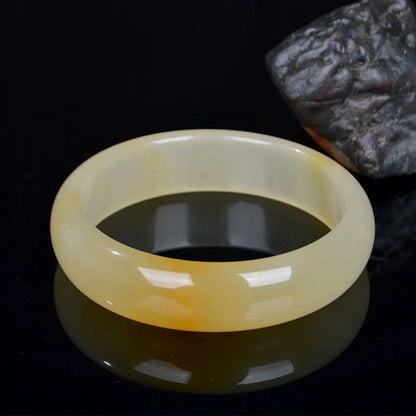 A polished natural jade bracelet in a traditional Chinese style, shown with a size guide for 54mm to 62mm.