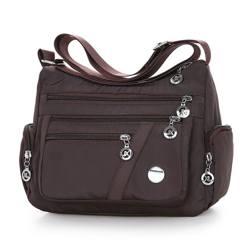 Women's nylon shoulder bag with multi-pocket design, zip opening and detachable handle in red, purple, black or army green