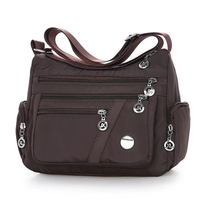 Women's nylon shoulder bag with multi-pocket design, zip opening and detachable handle in red, purple, black or army green