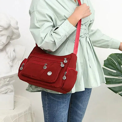Women's nylon shoulder bag with multi-pocket design, zip opening and detachable handle in red, purple, black or army green