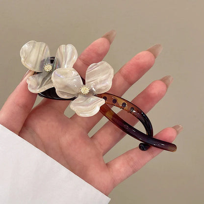 Retro flower bobby pin with acrylic petals in blue, light blue, beige, and pink colour options