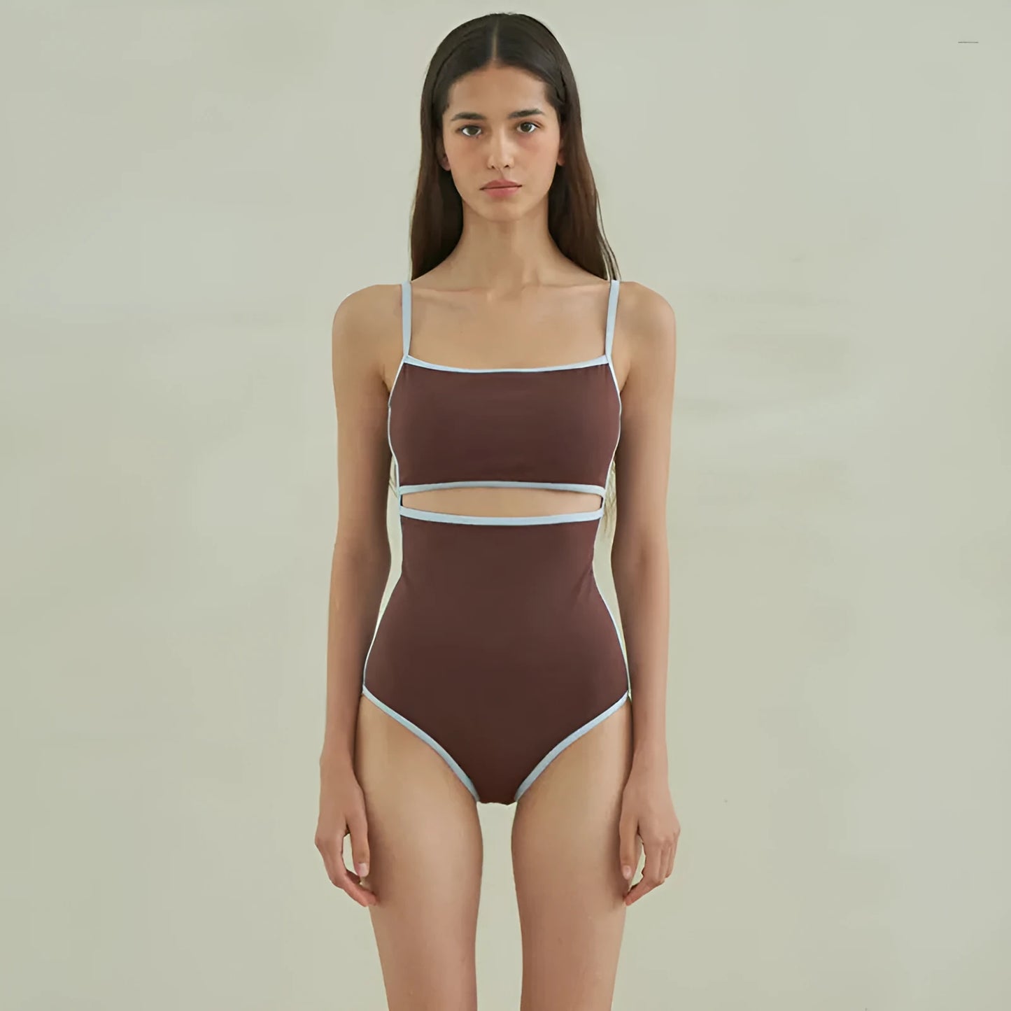 Brown women's one-piece swimsuit with triangle front and adjustable tie-back straps on a neutral background.