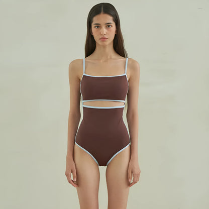 Brown women's one-piece swimsuit with triangle front and adjustable tie-back straps on a neutral background.