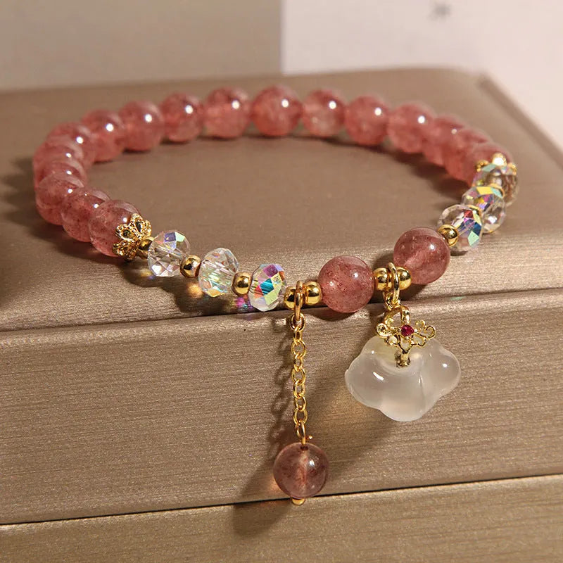 Women's strawberry quartz and white agate crystal bracelet with auspicious cloud charms on elasticated cord