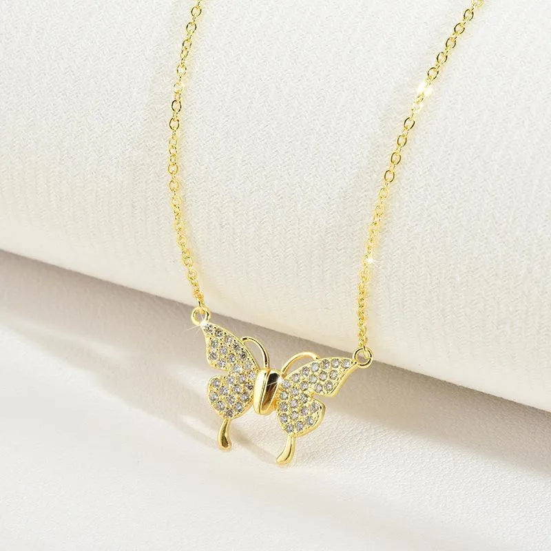 Close-up of a gold titanium steel twisted chain necklace with a magnetic butterfly clasp.
