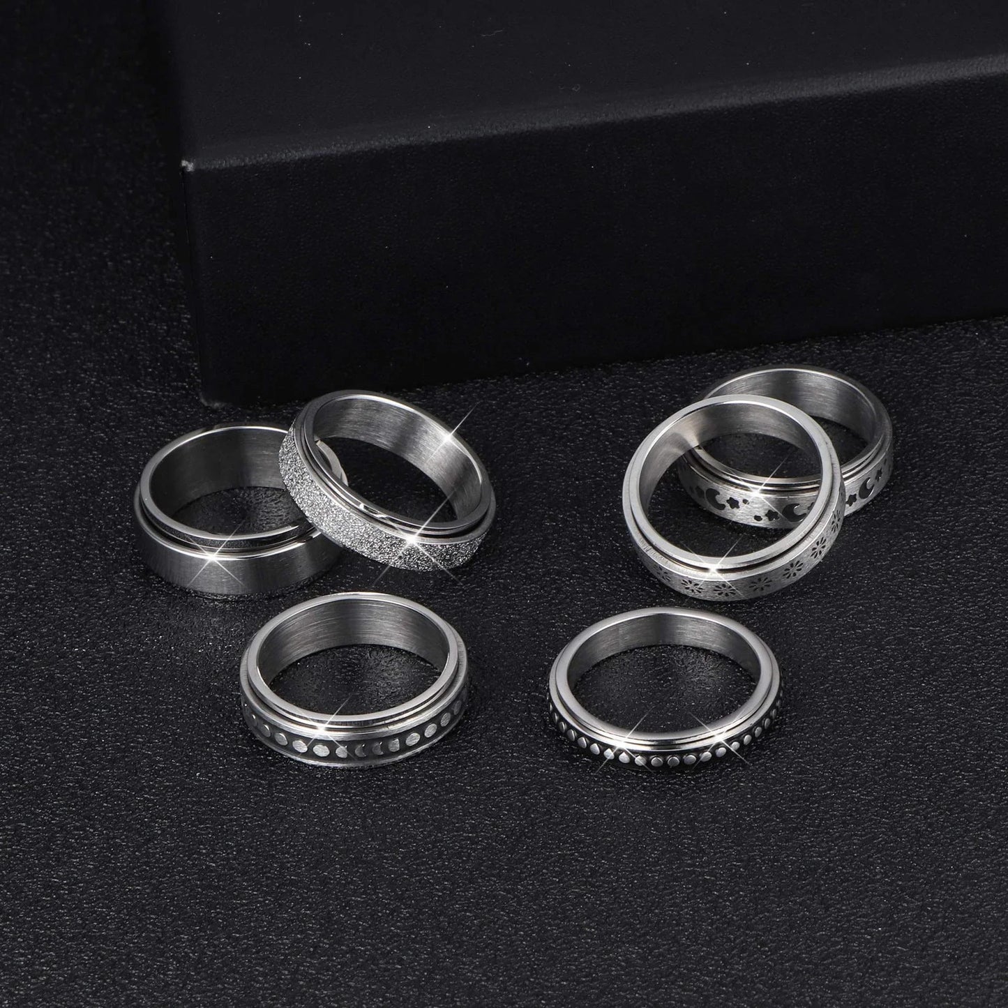 Rotatable stainless steel spinner ring with moon and star designs for anxiety relief and style